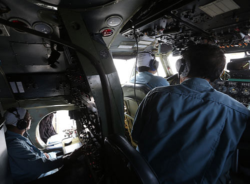 A cabin crew of Division 918 of the Vietnam Air Force is onboard a flying Soviet-made AN-26 during a search operation for the missing Malaysian Airlines Boeing 777 over the South China Sea Monday, March 10, 2014. Dozens of ships and aircraft have failed to find any piece of the missing Boeing 777 jet that vanished more than two days ago above waters south of Vietnam as investigators pursued 'every angle' to explain its disappearance, including hijacking, Malaysia's civil aviation chief said Monday. AP