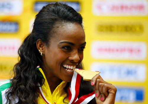 Ethopia's Genzebe Dibaba celebrates after winnning gold in the women's 3000m final during the world indoor athletics championships at the ERGO Arena in Sopot March 9, 2014. REUTERS