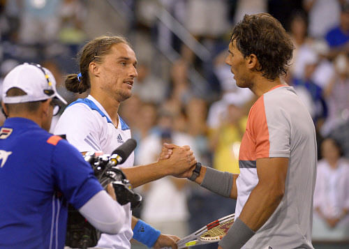 Alexandr Dolgopolov, left, of Ukraine, shakes hands with Rafael Nadal, of Spain, after defeating him in their match at the BNP Paribas Open tennis tournament, Monday, March 10, 2014, in Indian Wells, Calif. Dolgopolov won 6-3, 3-6, 7-6 (5). (AP Photo)