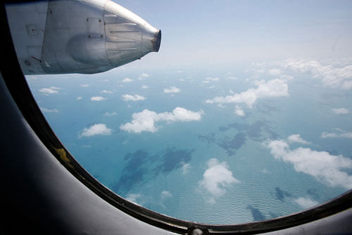 Clouds hover outside the window of a Vietnam Air Force search and rescue aircraft An-26 on a mission to find the missing Malaysia Airlines flight MH370, off Vietnam's Tho Chu island March 10, 2014. The disappearance of a Malaysian airliner about an hour into a flight to Beijing is an 'unprecedented mystery', head of Malaysia's Civil Aviation Authority Azharuddin Abdul Rahman said on Monday, as a massive air and sea search now in its third day failed to find any trace of the plane or 239 people on board. REUTERS