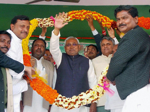 Bihar Chief Minister Nitish Kumar being garlanded by supporters during Sankalp Yatra in Bagha on Wednesday. PTI Photo