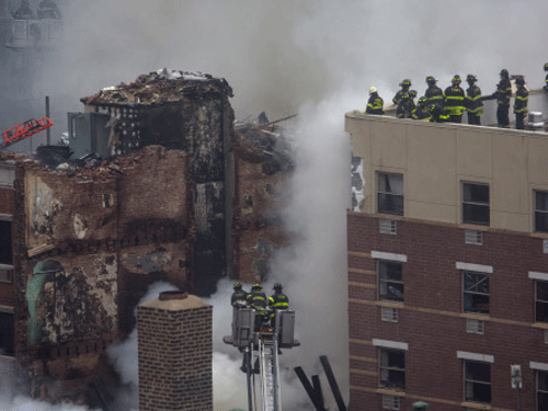 New York City firefighters examine the rubble at an apparent building explosion fire and collapse in the Harlem section of New York Reuters Image