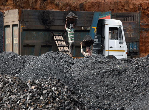 Indian laborers load coal into a truck at a roadside coal depot at Khliehriet in Meghalaya, March 12, 2014, AP