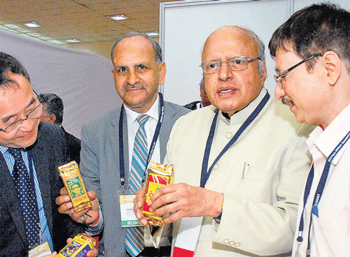Dr Pingfan Rao, president of the International Union of Food Science and Technology, hands over a copy of the book 'Nutra Sector Overview' to Prof M S Swaminathan at the 9th  Nutra India Summit in the City on Wednesday. DH photo