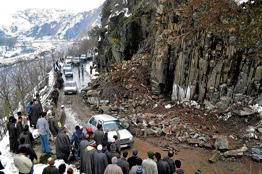 BOULDER TROUBLE: Locals clear rubble from the Srinagar-Muzaffarabad road after a landslide in Jammu and Kashmir on Thursday.  PTI