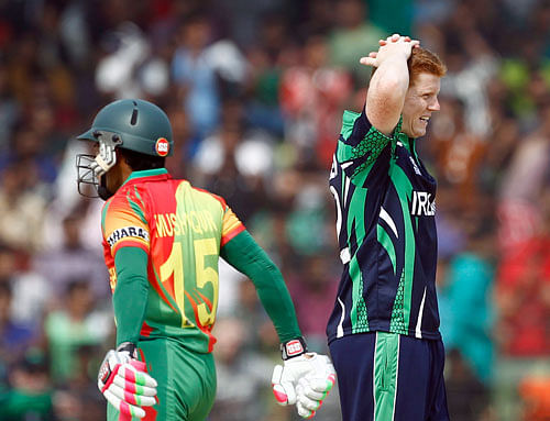 Ireland's Kevin O'Brien, right, reacts after delivering a ball during a warm up cricket match against Bangladesh ahead of the ICC World Twenty20 Cricket tournament in Fatullah, near Dhaka, Bangladesh, Friday, March 14, 2014. AP