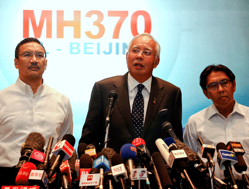 Malaysian Prime Minister Najib Razak (C) addresses reporters about the missing Malaysia Airlines flight MH370, as Transport Minister Hishammuddin Hussein (L) and Department of Civil Aviation's Director General Azharuddin Abdul Rahman (R) stand by him, at the Kuala Lumpur International Airport March 15, 2014. Najib said on Saturday that the movements of the missing Malaysia Airlines Flight MH370 were consistent with a deliberate act by someone who turned the jet back across Malaysia and onwards to the west. REUTERS