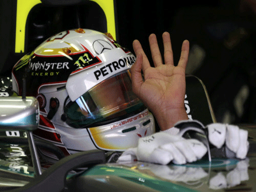Mercedes Formula One driver Lewis Hamilton of Britain waves in the garage during the third practice session of the Australian F1 Grand Prix. Hamilton captured pole position for Mercedes for the season-opening Australian Grand Prix in a thrilling finish to a rain-hit qualifying session on Saturday, while Formula One champion Sebastian Vettel failed to make the top 10. Reuters Photo