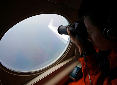 A Japan Coast Guard takes photos from the Gulfstream V Jet aircraft during a search for the missing Malaysia Airlines MH370 plane over the South China Sea. With sleuths probing the disappearance of Malaysian Airlines flight MH370 bound for Beijing from Kuala Lumpur having proposed that the aircraft could have crashed in the Bay of Bengal or somewhere in the deep southern side of the Indian ocean, the Indian Space Research Organisation (Isro) might assist in the search for the plane.  Reuters