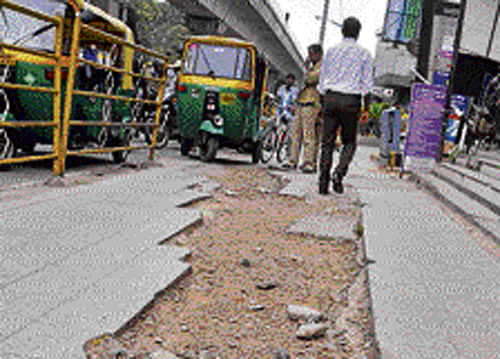 POOR MAINTENANCE:  Pavements are in bad shape even  in the city's Central Business  District. Broken tiles, potholes  and filth are everywhere.