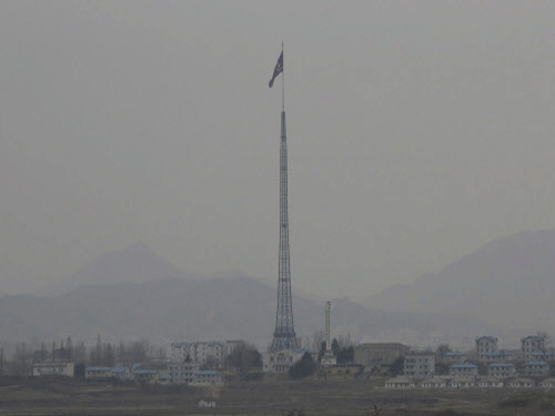 A North Korean flag flutters in the wind in the village of Gijungdong near the north side of the border village of Panmunjom. North Korea today test-fired ten rockets into the sea. AP Photo