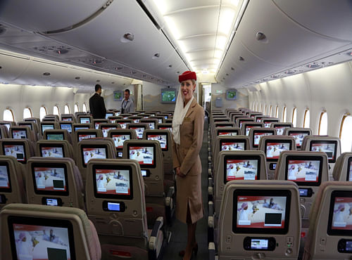 A stewardess stands inside an Emirates A380 aircraft, the world's largest passenger airline, during the fourth Indian Aviation show at Begumpet airport in Hyderabad, AP Photo