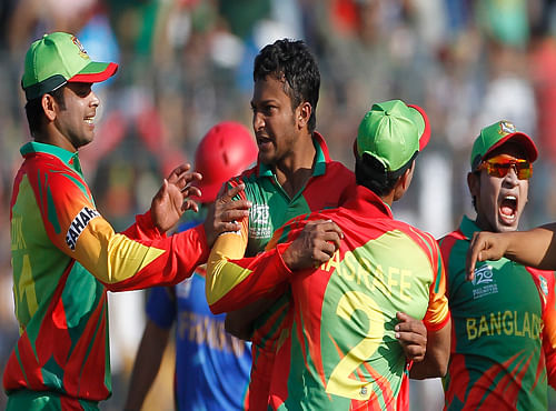 Bangladesh's Shakib Al Hasan reacts as other fielders congratulate him after dismissing Afghanistan's Najeeb Tarakai successfully during their ICC Twenty20 World Cup match. Reuters