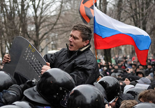A pro-Russian demonstrator scuffles with police during a rally in Donetsk March 16, 2014. Ukraine accused 'Kremlin agents' on Saturday of fomenting deadly violence in Russian-speaking cities and urged people not to rise to provocations its new leaders fear Moscow may use to justify a further invasion after its takeover of Crimea. REUTERS