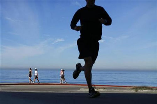 Taking part in vigorous exercise such as running, rapid cycling or rugby cuts the risk of catching flu. Reuters file photo