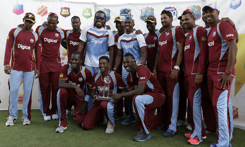 The West Indies cricket team poses with the trophy after beating England 2-1, in the series of three T20 International cricket matches at the Kensington Oval in Bridgetown, AP