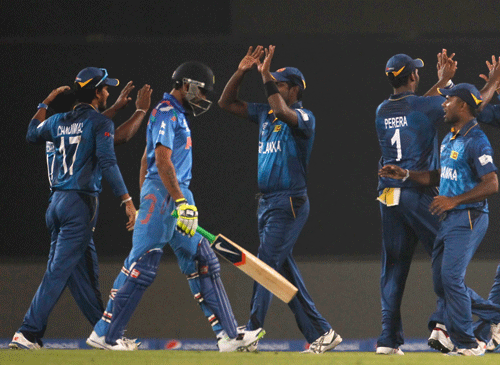 Ravindra Jadeja (2nd L) leaves the field as Sri Lanka's fielders celebrate his dismissal during their warm-up match of ICC Twenty20 World Cup at the Sher-E-Bangla National Cricket Stadium in Dhaka March 17, 2014. REUTERS