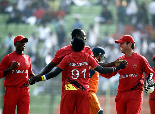 Zimbabwe's players celebrate the dismissal of the Netherlands Michael Swart during their ICC Twenty20 Cricket World Cup match in Sylhet, Bangladesh, Wednesday, March 19, 2014.  AP Photo