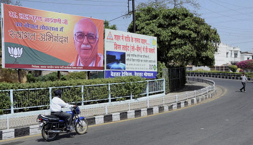 A hoarding welcoming senior BJP leader LK Advani put up along a road in Bhopal on Wednesday. PTI Photo