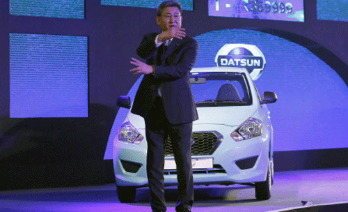 Kenichiro Yomura, President of Nissan Motor India, gestures in front of a 'Datsun GO' car while speaking with the reporters during its launch in New Delhi March 19, 2014. GO, whose price will range from 312,270 rupees to 369,999 rupees, will compete in India's crowded small-car market, which includes top Indian carmaker Maruti Suzuki's popular Alto 800 hatchback, which starts at about 276,000 rupees, Reuters