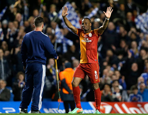 Galatasaray's Didier Drogba waves to the crowd at the end of the Champions League round of 16 second leg soccer match between Chelsea and Galatasaray at Stamford Bridge stadium in London Tuesday, March 18, 2014. AP