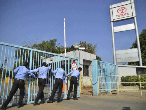 Ending the five-day long impasse following strike by workers demanding wage hike, Toyota Kirloskar Motor management today agreed to lift the lockout of its two plants at Bidadi near here on March 24 after government's conciliatory efforts. AP Photo