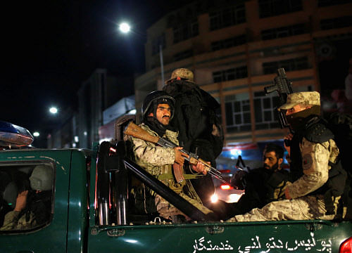 Afghan security personnel arrive near the Serena hotel, during an attack in Kabul March 20, 2014. Taliban gunmen attacked the luxury Serena hotel on Thursday in the centre of the Afghan capital Kabul, police said, and four of the assailants were killed in a shootout with Afghan security forces. REUTERS