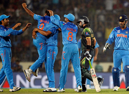 Pakistan's Ahmed Shehzad leaves the field as India's fielders celebrate his dismissal during their match of ICC Twenty20 World Cup at the Sher-E-Bangla National Cricket Stadium in Dhaka March 21, 2014. REUTERS