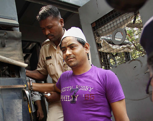One of four men convicted for gang raping a photojournalist last year, is taken to the Session Court from Arthur Road Jail in Mumbai on Thursday. The court is expected to pronounce the quantum of punishment on Friday. PTI Photo