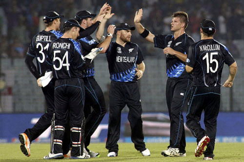 New Zealand's cricket captain Brendon McCullum, center, celebrates with teammates the dismissal of an England wicket during an ICC Twenty20 Cricket World Cup match in Chittagong, Bangladesh, Saturday, March 22, 2014. (AP Photo)