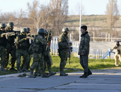 Russian troops used armoured vehicles, automatic gunfire and stun grenades on Saturday to seize a Ukrainian airbase in Crimea a day after President Vladimir Putin signed laws completing Russia's annexation of the Black Sea peninsula. Reuters photo