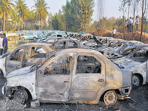 As many as 24 cars, valued at Rs 40 lakh, were destroyed in an accidental fire at a car dump yard in  Kadubisanahalli on Monday. DH Photo