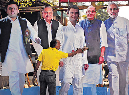 king size: An artist cleans a cut-out of Congress vice-president Rahul Gandhi, beside cut-outs of Uttar Pradesh Chief Minister Akhilesh Yadav, Akhilesh's father and chief of Samajwadi Party Mulayam Singh Yadav, BJP president Rajnath Singh and Gujarat Chief Minister Narendra Modi, put on display for sale in Ghaziabad on Monday. REUTERS