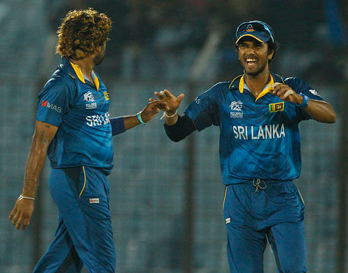 Sri Lanka's Lasith Malinga, left, celebrates with his team captain Dinesh Chandimal the wicket of Netherlands's Mudassar Bukhari during their ICC Twenty20 Cricket World Cup match against Netherlands in Chittagong, Bangladesh. South Africa were Tuesday fined for maintaining a slow over-rate during their ICC World Twenty20 Bangladesh 2014 Group 1 encounter against New Zealand at Zahur Ahmed Chowdhury Stadium in Chittagong Monday. AP