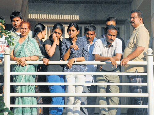 Mourning family: Relatives and family friends gather outside the house of Uday Raj Singh, a former banker, who was murdered by a seven-member gang at his house in Wilson Garden on Tuesday. His wife Susheela was injured in the attack. DH Photo