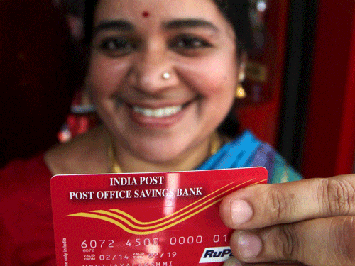 The Mangalore postal division's first ATM for postal savings account holders will be set up at head office in Pandeshwar shortly, said Mangalore division Senior Superintendent of Post Offices K A Devaraj. A customer shows her ATM card of the India's first Postal ATM in Chennai. PTI File Photo