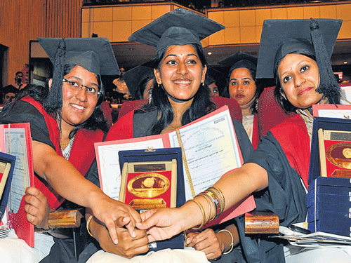 Dr Tasneem Kamalsha who won three gold medals is congratulated by Dr Abhinaya Venkatakrishnan who also won three medals and Dr Atibhi Goel who won four medals at the 16th annual convocation of RGUHS in Bangalore on Wednesday. DH Photo