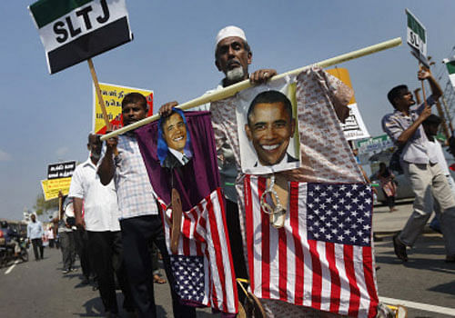 A man, carrying depictions of U.S. President Barack Obama, protests against the UN and U.S resolution against Sri Lankan war crimes, during a demonstration march towards the U.S embassy in Colombo March 26, 2014, Reuters photo