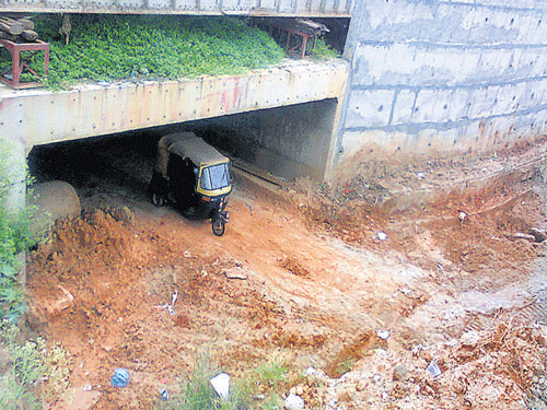 Even mini buses can't pass through the narrow underpass at Vijinapur. DHNS