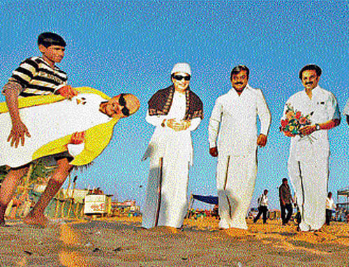 life size: A worker carries a cut-out of DMK party chief M Karunanidhi next to the cut-outs of other political leaders on display at Marina beach ahead of general election in Chennai on Thursday. REUTERS