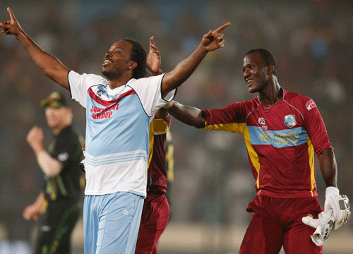 West Indies' captain Darren Sammy, right, smiles as teammate Chris Gayle dances to celebrate their win over Australia in the ICC Twenty20 Cricket World Cup match in Dhaka, Bangladesh, Friday, March 28, 2014. West Indies' won the match by six wickets. (AP Photo)