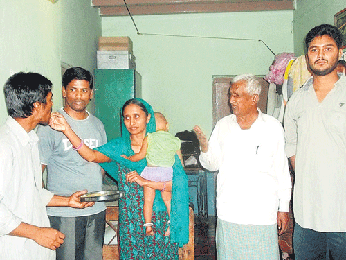 Lost and found Members of Ibrahim Sharief's family  distribute sweets on his arrival in Yashwantnagar village in Sandur taluk of Bellary district on Friday. A senior officer with the IBM,  he went missing from Bhubaneswar last  November. DH Phoyo