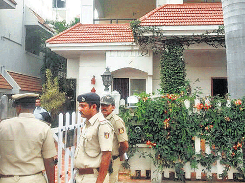 Police guard the house of realtor Kaushik Sharma who hanged himself after killing wife and children, at Vakil Garden near Talaghattapura  on Friday. DHNS