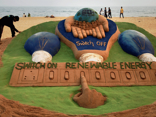 Puri: Sand artist Sudarshan Pattnaik creates a sand sculpture on the eve of earth hour day at Puri beach on Friday. PTI Photo
