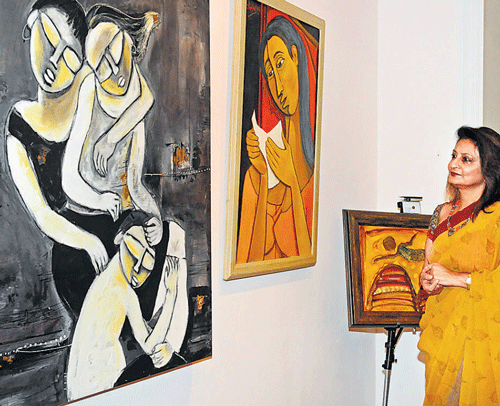 A visitor looks at the artworks at Kala for Vidya, an exhibition organised by Rotary Club of Bangalore in the City on  Saturday. dh photo