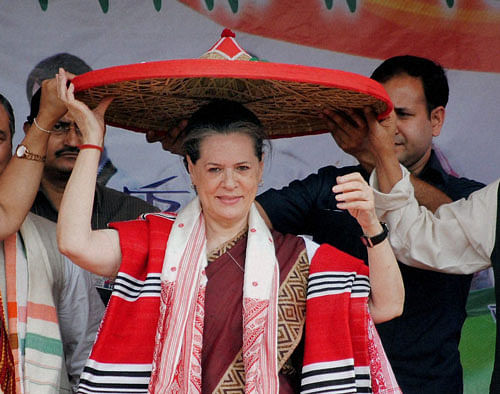 UPA Chairperson Sonia Gandhi being felicitated with traditional Assamese Japi (Hat) during an election campaign rally at North Lakhimpur,Assam on Sunday.PTI Photo