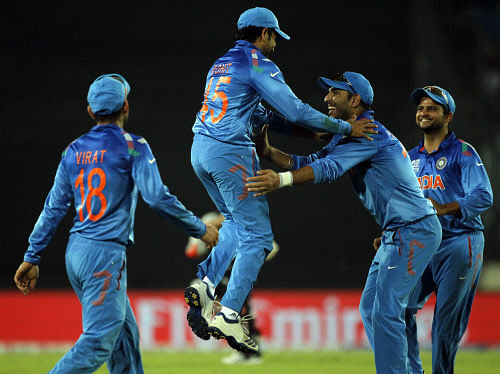 India's fielders celebrate the dismissal of Australia's Shane Watson during their ICC Twenty20 World Cup match at the Sher-E-Bangla National Cricket Stadium in Dhaka March 30, 2014. REUTERS