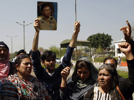 Supporters of former Pakistani President Pervez Musharraf shout slogans outside the Special Court formed to try him for treason in Islamabad March 31, 2014. Musharraf was today indicted by a court on five counts of high treason and his plea to travel abroad rejected as he became Pakistan's first ever military ruler to face criminal prosecution that entails death penalty. Reuters
