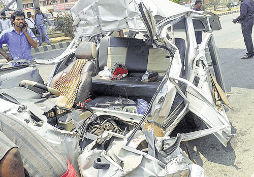 The mangled remains of the car which was involved in an accident, killing three of a family, near Nelamangala on Tuesday. DH photo