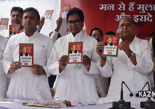 Samajwadi Party chief Mulayam Singh Yadav , Chief Minister of Uttar Pradesh state Akhilesh Yadav and the party's national general secretary Ramgopal Yadav hold their party's manifesto ahead of the country's general election, Reuters photo